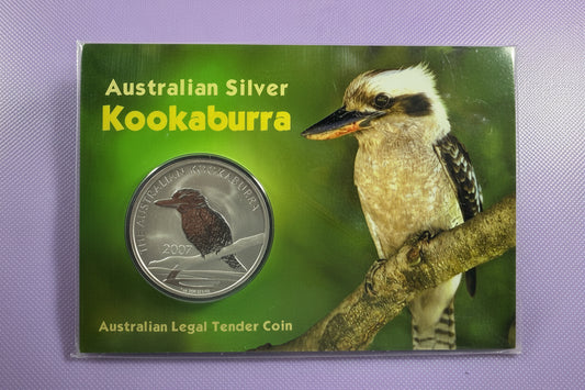 Australian Silver Kookaburra coin packaging on a purple surface